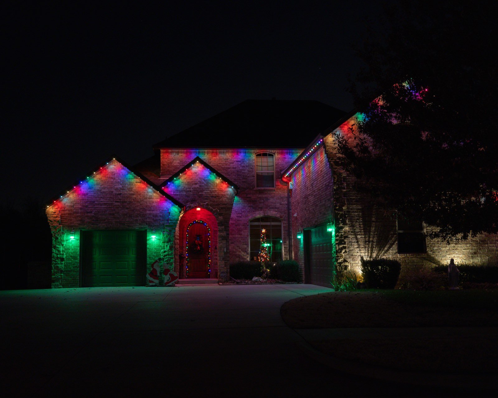 Permanent LED roofline trim lighting installed along the eaves of a two-story home